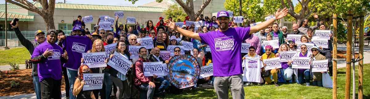 Group holding Re-elect Shamann Walton for Supervisor signs